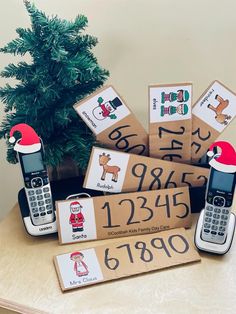 a group of cell phones sitting on top of a table next to a christmas tree