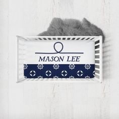 a baby crib with the name mason lee on it and an anchor in blue