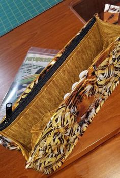 an open purse sitting on top of a wooden table