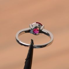 It is a lab ruby ring. The main stone is 7 mm*7 mm round cut.weight about 1.66 carats. The basic metal is sterling silver and plated with rhodium. To change the metal to a solid gold (white/rose) or platinum is also available, please ask for a quotation if you want. You can also go to my shop Home for more elegant rings: https://www.etsy.com/shop/godjewelry?ref=hdr_shop_menu Ruby is the July birthstone. More ruby rings: https://www.etsy.com/shop/godjewelry?section_id=20709238 Customization is al Classic Round Band Lab-created Ruby Jewelry, Classic Lab-created Ruby Round Band Jewelry, Round Cut Ruby Promise Ring With Center Stone, Red Solitaire Birthstone Ring, Classic Ruby Ring With Tension Setting For Gift, Red Solitaire Birthstone Ring With Round Band, Classic Ruby Ring With Tension Setting As Gift, Lab-created Ruby Promise Ring With Round Band, Formal Jewelry With Lab-created Ruby In Round Band