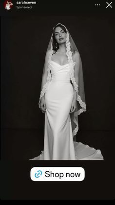 a black and white photo of a woman in a wedding dress with a veil over her head