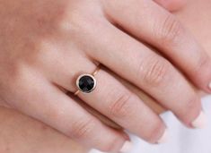 Black onyx 14K gold ring. A dainty, delicate black onyx gemstone ring, ideal for stacking for every woman who loves elegance. An excellent choice for anniversary gift or birthday gift for her. 100% handcrafted with love!D E T A I L S● Metal: 14K solid gold, 14K white gold or 14K rose gold● Gemstone: Black Onyx, briolette cut● Stone Diameter: 8mm (0.31in), 10mm (0.4in) and 12mm (0.5in) R I N G ∙ S I Z I N GFor General Reference:● we use standard US Ring Sizing● an average women's ring finger is s Minimalist Black Enamel Jewelry For Anniversary, Faceted Round Onyx Jewelry, Minimalist Black Faceted Jewelry, Black 14k Gold Band, Black 14k Gold Round Band Jewelry, 14k Gold Black Round Band Jewelry, Round Onyx Jewelry For Anniversary, Elegant Onyx Rings For Everyday Wear, Everyday Round Onyx Jewelry