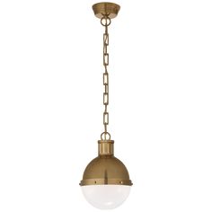 an antique brass pendant light with a white glass ball hanging from the bottom and chain around it