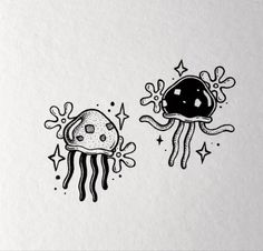 an ink drawing of two jellyfishs with stars and bubbles on the bottom one is black and white