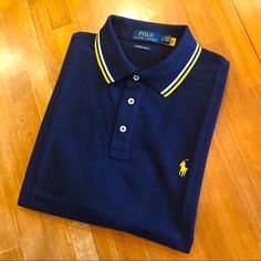 100% Cotton Custom Slim Fit Navy Blue Polo With Gold/White Trim On Collar And Sleeves, Gold Polo Spellout On Right Sleeve, And Gold Pony On Left Chest. Nwt. Qtn4s3x5ttd Navy Fitted Top With Contrast Stripes, Navy Fitted Top With Striped Collar, Fitted Navy Top With Striped Collar, Navy Polo Top With Striped Collar, Blue Polo Shirt With Striped Collar For Work, Classic Blue Polo Shirt With Contrast Stripes, Fitted Blue Top With Contrast Stripes, Preppy Blue Polo Collar Top, Sporty Blue Polo Shirt With Contrast Stripes