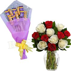 two bouquets of roses and chocolate bars in a vase with the same flower arrangement