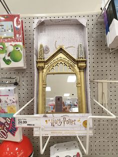 there is a harry potter mirror on the shelf in the store with other items around it