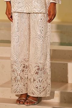 White flared pant with mirror jaal embroidery and cutwork detailing.
Components: 1
Pattern: Embroidery
Type Of Work: Mirror
Color: White
Other Details: 
Cutwork detailing
Note: Top worn by the model is not for sale
Occasion: Mehendi and Haldi - Aza Fashions Elegant Pants With Intricate Embroidery For Festive Occasions, Embroidered Bottoms For Wedding And Festivals, Bollywood Style Embroidered Bottoms For Wedding, Bollywood Embroidered Bottoms For Wedding, Bollywood Style Embroidered Wedding Bottoms, Elegant Pants For Eid Party, Straight Pants For Wedding And Eid, Eid Wedding Straight Pants, Eid Party Pants With Resham Embroidery