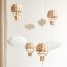 some kind of mobile that looks like hot air balloons hanging from the ceiling with clouds in them