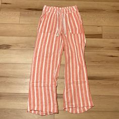 Women’s Indigo Rein Striped Pants Pre-Owned, But Practically Brand New! Even Though These Pants Are Peach, They Could Easily Pass For Red, Which Means They’re A Reasonable Choice For A Christmas Gift! Right? Plus, Day To Day Comfort Makes It All The More Special. Brand: Indigo Rein Size: Small - Color: Peach And White Material: 55% Linen, 45% Rayon Made In China Stripes Wide Leg Boho Vibes Perfect Comfy Stretchy Material Durable Drawstring Pockets Divine Vertical Stripe Pattern Beautiful Blend O Orange Summer Loungewear Bottoms, Pink Lounge Pants For Beach Season, Orange Bottoms With Pockets For Beach Season, Orange Cotton Bottoms For Vacation, Casual Orange Bottoms For Beach Season, Orange Vacation Pants With Pockets, Orange Cotton Pants For Vacation, White Loungewear, Boho Vibe