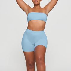 The Signature Skims Bandeau Top, Now Available As A Classic Strapless Swim Style. Perfect For The Beach And Beyond, This Top Also Features A Detachable Halter Strap For Additional Styling Options. Fits True To Size. Strapless Tube Top For Summer Workout, Stretch Tube Top For Sports In Summer, Summer Stretch Light Blue Tube Top, Stretch Light Blue Tube Top For Summer, Light Blue Stretch Tube Top For Summer, Summer Light Blue Stretch Tube Top, Blue Stretch Summer Tube Top, Blue Stretch Tube Top For Summer, Fitted Blue Tube Top For Beachwear