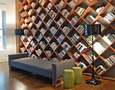 a living room filled with furniture and bookshelves covered in wooden bookcases