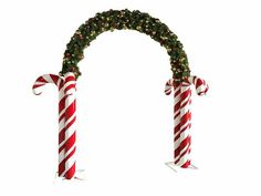 two candy canes with christmas decorations on them are hanging from the top of an arch