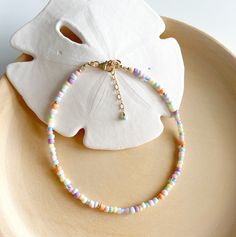 The Boa Vista anklet combines pastel coloured glass and gold beads to evoke that relaxed summer beach vibe! The Cape Verde Island of Boa Vista has some of the most beautiful stretches of beach that you'll find and it inspired the pastel ice cream colours of this ankle bracelet. Measures 9in and extends to 10in. Delivered in our pretty gift box, so fantastic as a present for a friend or to yourself! Matching bracelet https://www.etsy.com/uk/listing/1487665495/boa-vista-multi-coloured-beaded-bracelet Matching necklace https://www.etsy.com/uk/listing/1473482162/pastel-beaded-necklace-colourful-gold Shipping Uk: 2-3 days - Royal Mail 48hr tracked International standard delivery: 6- 14 days (delays can occur especially in busy periods) Please be aware that standard shipping is UNTRACKED and doe Multicolor Tiny Beads Bracelet For Beach Season, Multicolor Tiny Beads Bracelets For Beach Season, Multicolor Strand Anklets For Summer, Gold Beaded Bracelets For Beach Season, Handmade Pastel Beaded Bracelets For Beach, Multicolor Anklets As Beach Season Gift, Multicolor Anklets For Beach Season Gift, Bohemian Multicolor Strand Anklets, Multicolor Beaded Anklets For Vacation