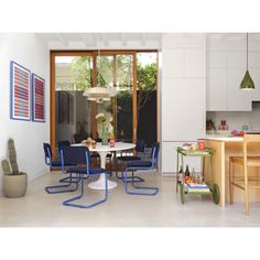 a dining room and kitchen area with blue chairs