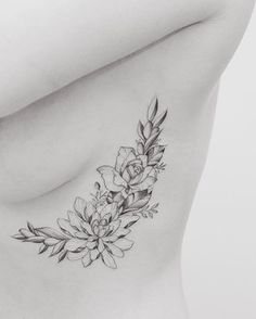 a black and white photo of a woman's stomach with flowers on the side