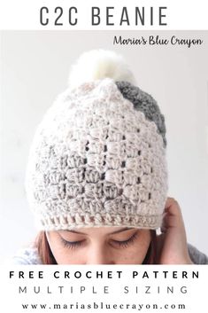 a woman wearing a crochet hat with a white pom - pom