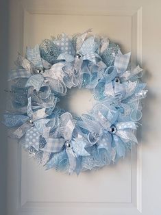 a blue and white wreath hanging on the front door