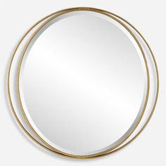 a round mirror with gold trim around the edges, hanging on a wall or ceiling