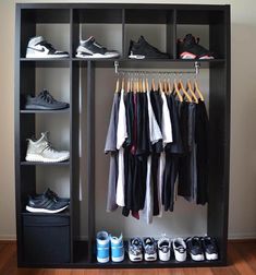 an organized closet with shoes, sneakers and t - shirts