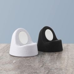 two black and white objects sitting on top of a counter