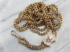 "Dating to the late 1800's or early 1900's, this rare rose gold Victorian chain is detailed with formed, ribbon links. The freely moving black enamel slide is original, and can be located along the chain to create any length 'drop' you feel comfortable with. The finishing beads of rose gold are a bright contrast to the dark patina of the rest of the piece. The craftsmanship is superb, each link forming a tiny work of art. Metal: Yellow Gold Material: Black Enamel Pendant/Slide Measurements: 20 x Antique Wheat Chain Jewelry Gift, Victorian Style Formal Jewelry With Chain, Victorian Wheat Chain Necklace For Formal Occasions, Victorian Curb Chain Jewelry, Antique Wheat Chain Necklace For Formal Occasions, Victorian Curb Chain Jewelry Gift, Victorian Curb Chain Jewelry As A Gift, Victorian Jewelry With Curb Chain As A Gift, Vintage Wheat Chain Jewelry For Formal Occasions