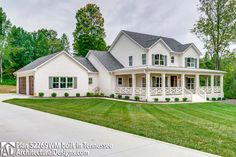 a large white house sitting on top of a lush green field