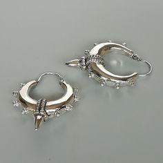 A PAIR of chunky ethnic style sterling silver spike hoops. Dimensions: Length (with spike) 33mm Width: (with spike) 25 mm Weight: 10.8 gm Price listed is for a PAIR of hoops. These earrings are made of 925 hypoallergenic sterling silver Can be packaged in a gift box. I can include a personal message from you if needed You are welcome to contact me at... bhavnakwintra1956@gmail.com For more beautiful pieces from my shop, please browse 👇 TOE RINGS: https://www.etsy.com/your/shops/TheSilverGame/to Hoop Earrings Chunky, Egyptian Jewelry, Ethnic Style, Sterling Silver Hoops, Toe Rings, Silver Hoops, Personal Message, Bali, Silver Rings