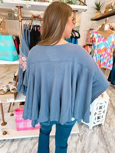 Add some floral flair to your wardrobe with our Take the Reign Embroidered Poncho Top! Made by Savanna Jane, this relaxed fit poncho style top features a large embroidered floral design on the chest. With a navy mineral wash and round neckline, you'll reign supreme in style. Relaxed Fit Navy Mineral Wash Large Embroidered Floral Chest Design Poncho Style Round Neckline Savanna Jane Brand 64% Cotton 36% Polyester Casual Cotton Poncho With Relaxed Fit, Bohemian Cotton Top With Batwing Sleeves, Bohemian Cotton Tops With Batwing Sleeves, Spring Loungewear Poncho With Batwing Sleeves, Embroidered Oversized Tops For Loungewear, Oversized Blue Embroidered Top, Casual Poncho For Spring Loungewear, Casual Spring Poncho For Loungewear, Spring Loungewear Tops With Floral Embroidery