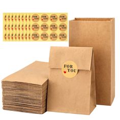 a brown paper bag with stickers on it next to several boxes and envelopes