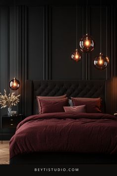 a bedroom with black walls and red bedding, hanging lights above the headboard