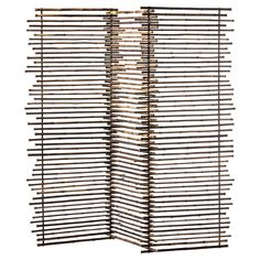 a room divider made out of wood sticks on a white background with no one in it