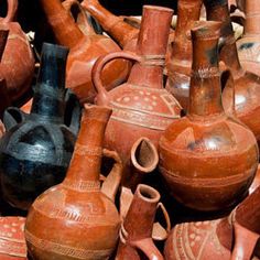 a pile of clay pots and vases sitting on top of each other