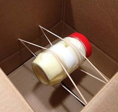 an open cardboard box with some white and red items in it