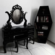 a black desk with a mirror and some books