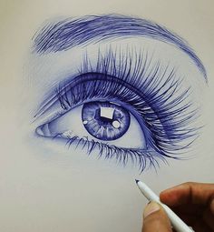 a drawing of an eye with long lashes and blue eyeshade is being drawn