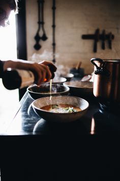 a man is cooking food in a pot on the stove