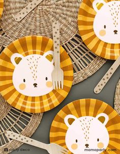 there are plates with animals on them and forks in front of the plate that is made out of paper