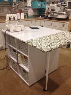 a sewing machine sits on top of a table in a room filled with crafting supplies