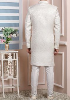 Ready-Made Sherwani With Trouser. Jacquard Brocade Fabric Top. Art Dupion Aligarhi Ready Made Trouser. Crafted in Chinese Collar Neck, and Full Sleeve. Satin Lining with Plain Work. High-Quality Matching Buttons. Please Note: The footwear shown in the picture is for presentation and photography purpose only. Color: There might be slight color variation due to lightings and flashes while photo shooting. The color may also vary because of different screen resolutions. Wash Care: Dry Clean Only. Traditional Party Wear, Indo Western Sherwani, Chinese Collar, Readymade Saree, Dupion Silk, Collar Neck, Silk Trousers, Top Art, Indo Western