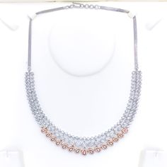 This exquisite 18k gold necklace set, weighing 59.0 grams, features a chic design adorned with dazzling diamonds. The combination of rose and white gold enhances its luxurious appeal, making it perfect for any special occasion. The set includes a necklace with a total diamond weight of 9.97 carats, featuring F-G color and VS quality diamonds in round shapes. The necklace has a length of 17.25 inches with adjustable 0.75-inch links and is secured with a hook lock. The matching earrings, each meas Dazzling Rose Gold Diamond Necklace, Rose Gold Diamond Cut Necklace For Formal Occasions, Dazzling Rose Gold Diamond Accents Necklace, Dazzling Rose Gold Diamond Necklace With Accents, Rose Gold Diamond Jewelry For Formal Occasions, Hand Set Rose Gold Necklace, Exquisite Rose Gold Diamond Necklace For Anniversary, Hand Set Rose Gold Bridal Necklace For Anniversary, Formal Rose Gold Diamond Jewelry