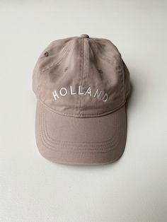 This Holland "Dad Hat" is a classic. The neutral tones are sure to match every outfit all year round. Embroidered locally in Grand Rapids. Regular fit 100% Cotton Hand wash Casual Brimmed Hat With Embroidered Logo, Beige Hat With Embroidered Logo And Short Brim, Casual Wide Brim Hat With Embroidered Logo, Trendy Khaki Cotton Hat, Beige Summer Hats With Embroidered Logo, Trendy Brown Hat With Embroidered Logo, Classic Spring Baseball Cap, Khaki Cotton Baseball Cap With Short Brim, Brown Cotton Brimmed Baseball Cap