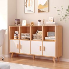 a room with a white chair and some pictures on the wall next to a book shelf