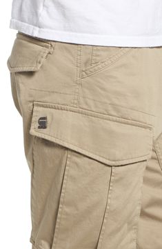 Stretch-cotton pants in a tapered profile rock a modern, utilitarian look with cargo-style pockets and ergonomic seaming for a more active fit. 32" inseam; 14" leg opening; 10" front rise; 15" back rise (size 32) Zip fly with button closure Side slant pockets; back flap pockets; side cargo pockets 97% cotton, 3% elastane Machine wash, dry flat Imported Tapered Cargo Pants With Side Pockets For Work, Khaki Tapered Leg Cargo Pants, Khaki Tapered Cargo Jeans With Flap Pockets, Khaki Tapered Leg Cargo Pants With Hip Pockets, Khaki Cargo Jeans With Hip Pockets And Tapered Leg, Khaki Tapered Leg Cargo Jeans With Hip Pockets, Utility Tapered Pants With Cargo Pockets, Tapered Utility Cargo Pants With Straight Leg, Urban Cargo Pants With Tapered Leg And Hip Pockets