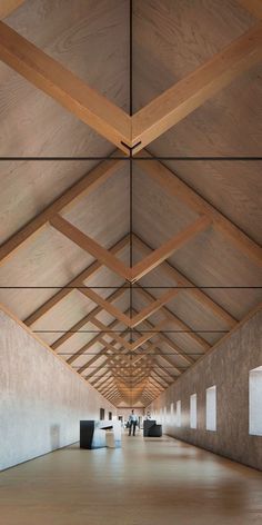 an empty room with wooden ceiling and white walls