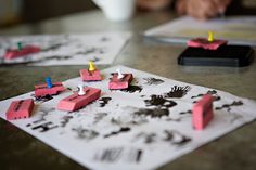 several pieces of paper that have been placed on top of a table with candles in them