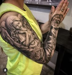 a woman is holding her hands up in front of her face with tattoos on it