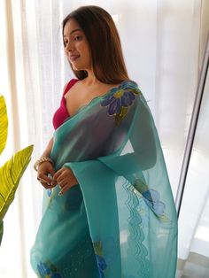 Be stylish and create and ascertain a classy look on everyone by draping this sky blue color saree on organza material with a digitally printed design with hand work all over. Paired up this sky blue organza material saree with a pink color plain blouse. This delicate saree is 5.50 meters long and comes with fully unstitched blouse material. Saree always gives a decent look, everyone looks beautiful in its drape saree linen saree are the best option for party wear, or festival wear choose to loo Traditional Blue Pre-draped Saree With Floral Embroidery, Blue Organza Unstitched Blouse Piece, Blue Organza Pre-draped Saree With Pallu, Blue Organza Pre-draped Saree For Diwali, Blue Georgette Blouse Piece With Floral Embroidery, Blue Georgette Saree With Floral Embroidery, Blue Silk Saree With Floral Embroidery, Traditional Blue Organza Blouse Piece, Semi-stitched Blue Pre-draped Saree With Floral Embroidery