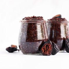 two glass jars filled with different types of food and one has blackberries in it