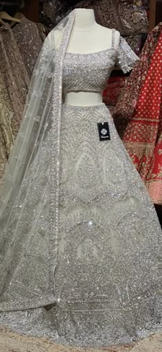 Iced cube sliver lehenga with frosted crystal embroidery teamed with a spaghetti strap blouse with crystal embroidery and net dupatta. Fabric: Net Size: 38 Ready to Ship! Designer Embellished Silver Lehenga, Designer Silver Embellished Choli, Designer Embellished Silver Choli, Party Silver Sharara With Intricate Embroidery, Party-ready Silver Sharara With Intricate Embroidery, Festive Silver Hand Embellished Dupatta, Festive Hand Embellished Silver Dupatta, Festive Silver Hand-embellished Dupatta, Silver Anarkali Style Hand Embellished Sharara